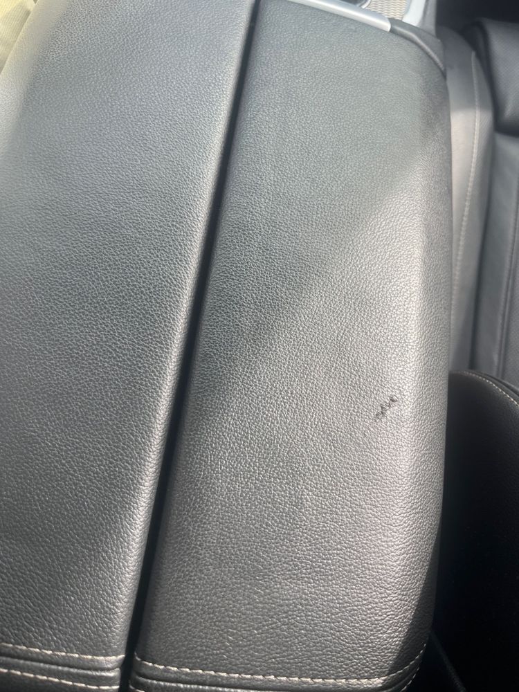 Centre armrest has leather damage